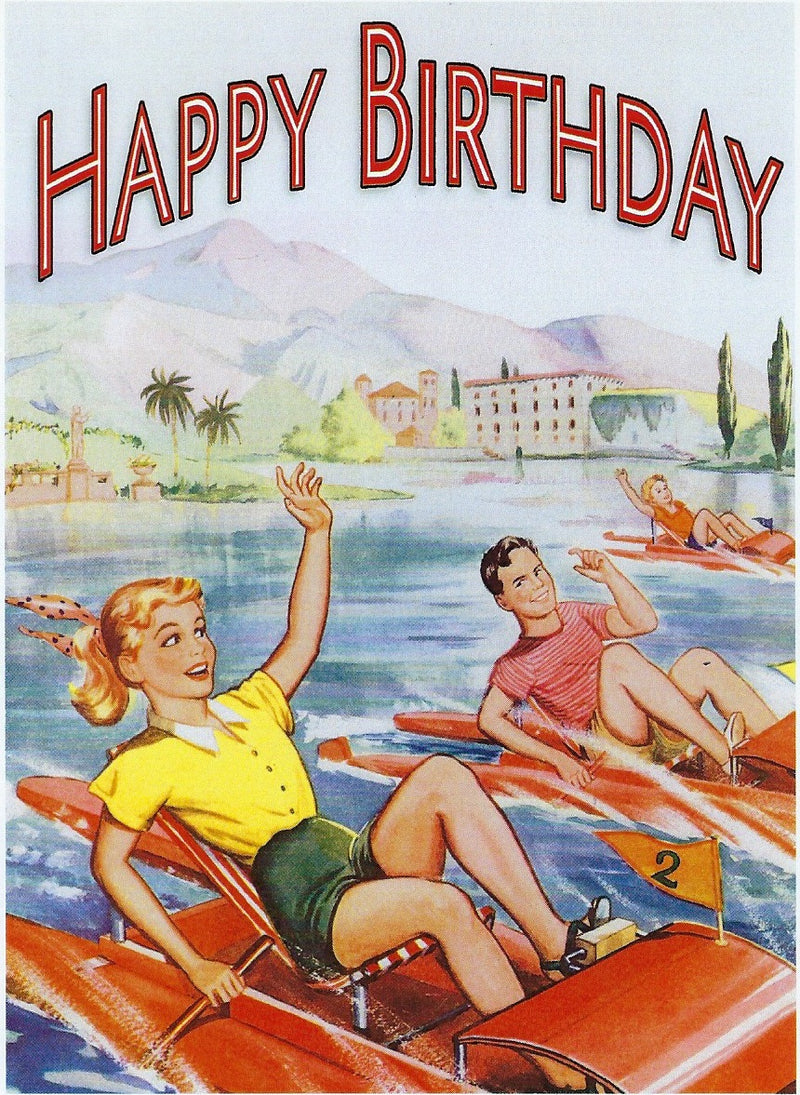 A vintage "happy birthday" Greeting Cards featuring two cheerful people water-skiing on a scenic lake with mountains and a quaint town in the background.