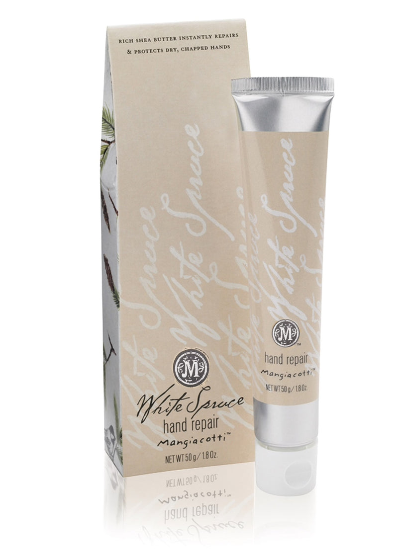 A tube of Mangiacotti White Spruce Hand Repair with shea butter and essential oils, standing next to its packaging box featuring elegant script and floral designs.