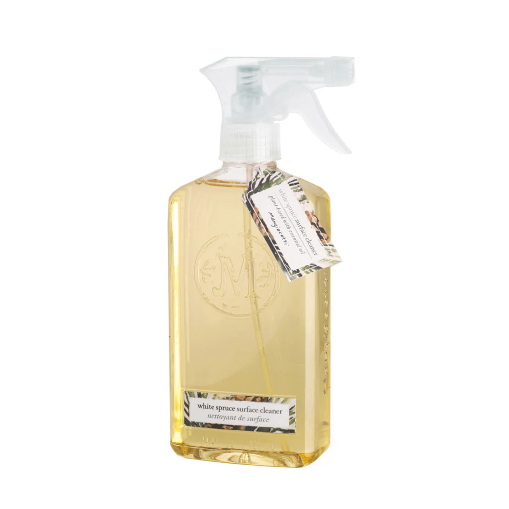 Transparent spray bottle containing yellow liquid, labeled as "Mangiacotti White Spruce Natural Surface Cleaner." The bottle has a white spray nozzle and a label with black text.