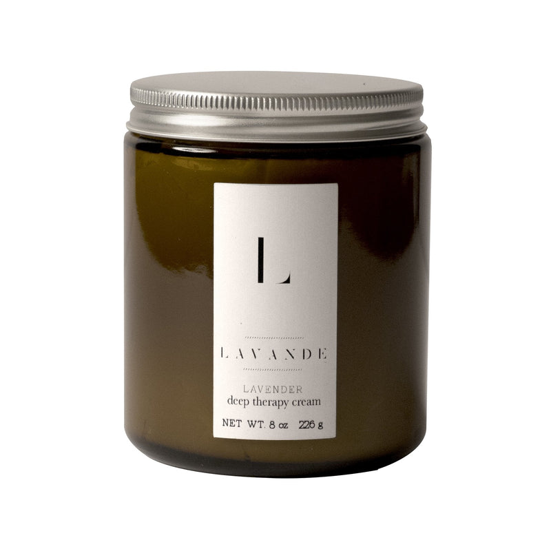 A glass jar containing Lavande - Deep Therapy Cream 8oz with healing benefits, featuring a white label with black text, isolated on a white background. The jar has a silver lid and holds 8 ounces.