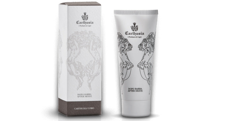 A tube of Carthusia I Profumi de Capri Salone da Barba After Shave cream next to its packaging box, both adorned with intricate, monochrome designs featuring heraldic imagery, ideal for men's grooming.