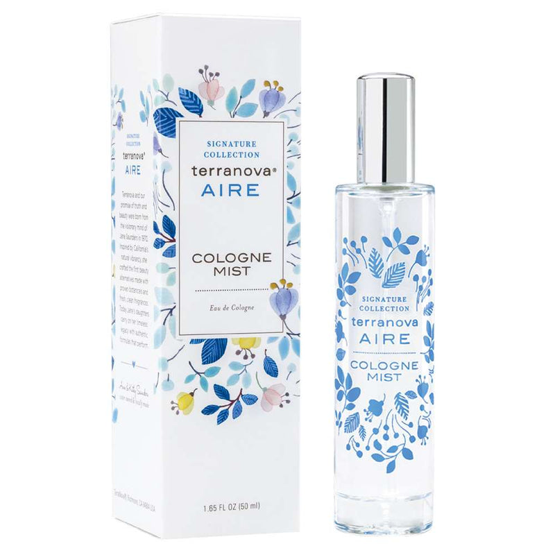 A bottle of Terra Nova Aire Cologne Mist - 1.65 Fl Oz next to its packaging box, both decorated with a floral blue and white design featuring white tea accents. The box displays the product name and size.