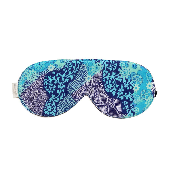 The elizabeth W Silk Sleep Mask - Aqua Origami features sueded silk with a vibrant blue and teal abstract pattern inspired by floral and nature designs.