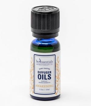 A small bottle of "BC Essentials - Diffuser Oil - Awakening" by BC Essentials, featuring Grapefruit Essential Oil, with a green-tinted glass and a black cap, against