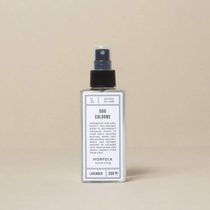 A bottle of Norfolk Natural Living Lavender Dog Cologne, formulated for sensitive skin, labeled in a simple design, against a neutral beige background. The container features a spray nozzle and holds 200 ml.