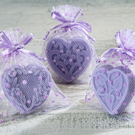 Three Sonoma Lavender - Lavender Mini Bath Salts & Soap heart-shaped sachets with polka dots, tied with ribbons, arranged on a rustic wooden surface by Sonoma Lavender.