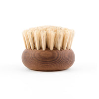 A round Andrée Jardin Heritage Ash Wood Body Brush with stiff bristles by Andrée Jardin, isolated on a white background. The wood shows natural grain patterns.