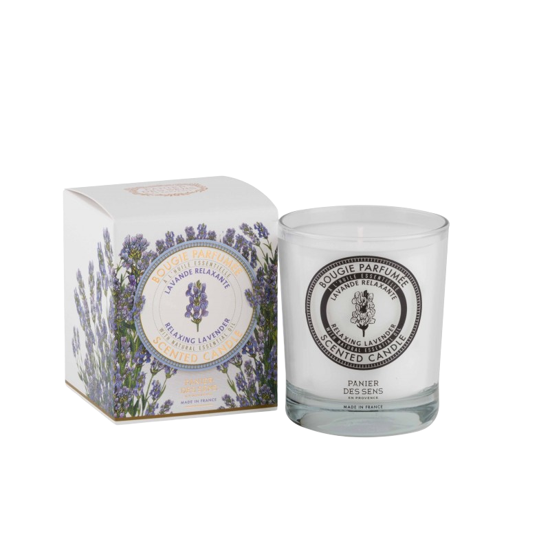 A Panier Des Sens Relaxing Lavender Scented Candle made with high-quality waxes in a clear glass holder next to its packaging box, which features a floral lavender design and the text "cologne parfum - spring lavender.