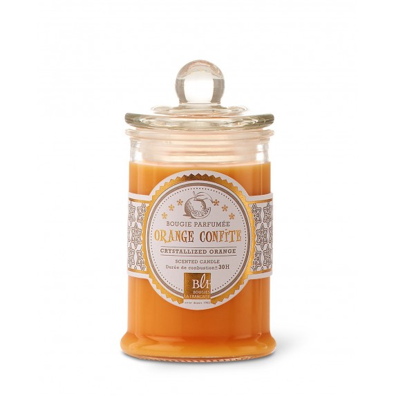 A Bougies La Francaise scented candle with a clear glass jar and a lid, labeled "Candied Orange Fragrance." The candle wax is an orange color.