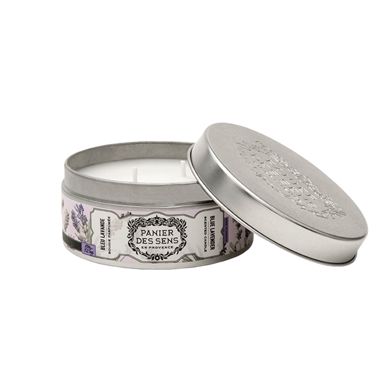 A Panier Des Sens Blue Lavender scented candle made with quality waxes in a decorative metal tin with a floral pattern on the lid, labeled "panier des sens" and featuring true lavender imagery around the sides.