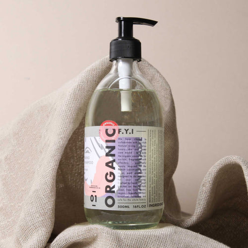 A clear bottle of Made & Sent Calming Dog Shampoo 500ml with a black pump dispenser, labeled with colorful, modern design elements, placed against a neutral beige background.
