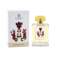 A Carthusia I Profumi de Capri perfume box and bottle labeled "Carthusia Lady Eau de Parfum - 50ml", featuring a white musk scent. The box is white with a colorful floral design and a crest, and the clear glass bottle features a gold accent.
