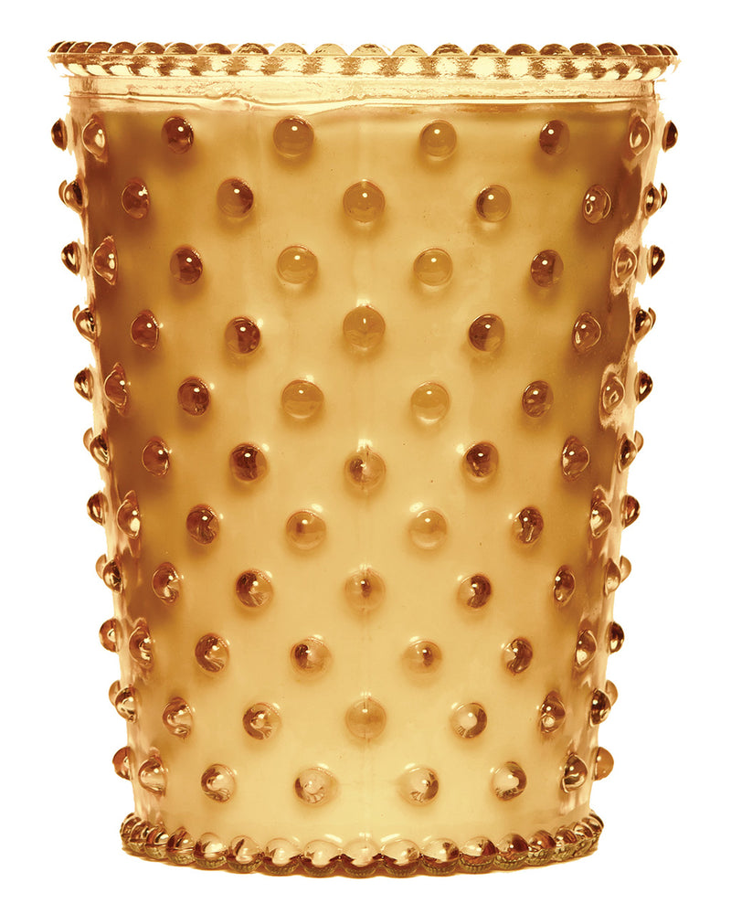 A Simpatico NO. 13 Cedarwood Bonfire Hobnail Glass Candle with raised dot patterns and a scalloped rim, isolated against a white background, perfect for holding a hand-poured candle.