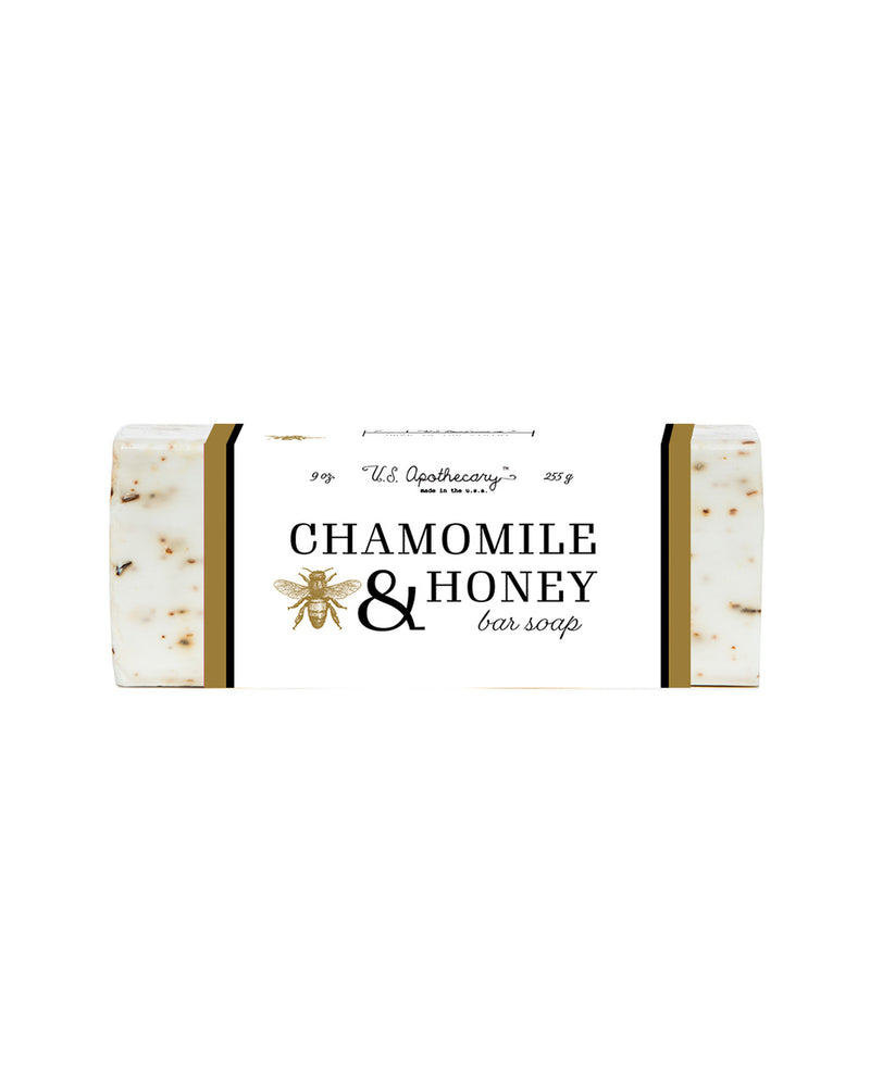 A U.S. Apothecary Chamomile & Honey Triple Milled Bar Soap labeled "no. 157 the apothecary" with botanical illustrations, displayed on a white background.