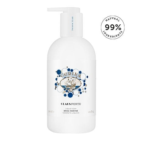 Product image of Claus Porto 1887 Cerina liquid soap in a white bottle with a pump, labeled "Brise Marine," featuring blue decorative elements and a "99% natural ingredients" badge, enriched with glycerin