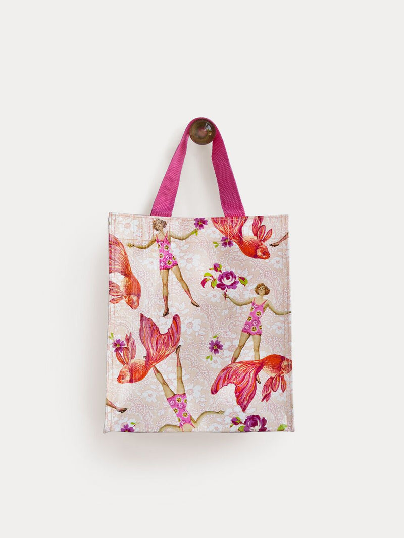 A TokyoMilk Tote Bag - Coral Goldfish Small Tote featuring a whimsical pattern of pink flamingos, gymnasts, and delicate flowers on a soft textured beige background, with a vibrant pink strap. Perfect as a Margot Elena treasure.