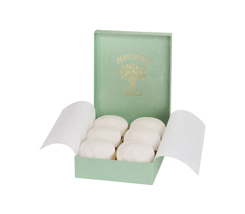 A green box labeled "Rancé" containing six round, white Rancé Classic Soaps - Corylopsis with natural antiseptic properties, each embossed with decorative patterns, against a white background.