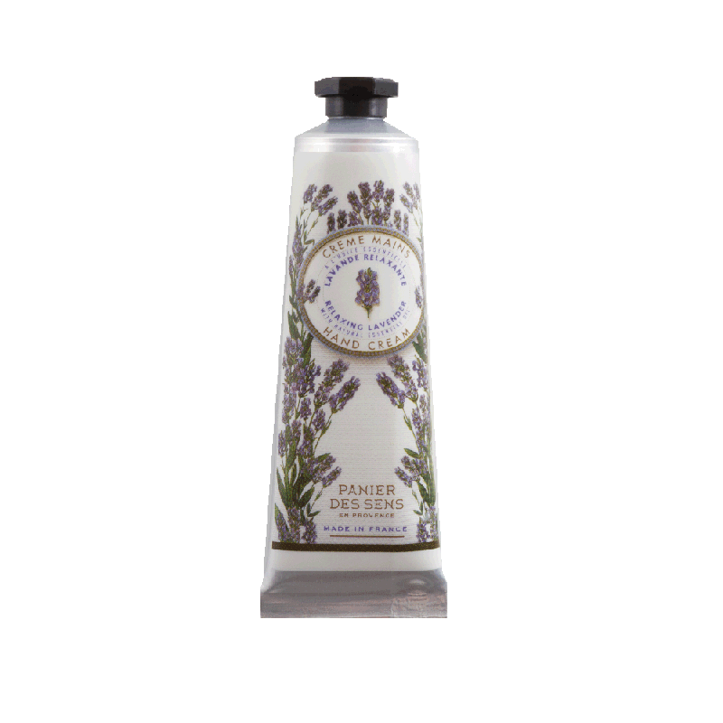 A cylindrical mini size bottle of Panier Des Sens Lavender Hand Cream 1 oz with lavender illustrations and text, featuring a black flip-top cap, against a green background.