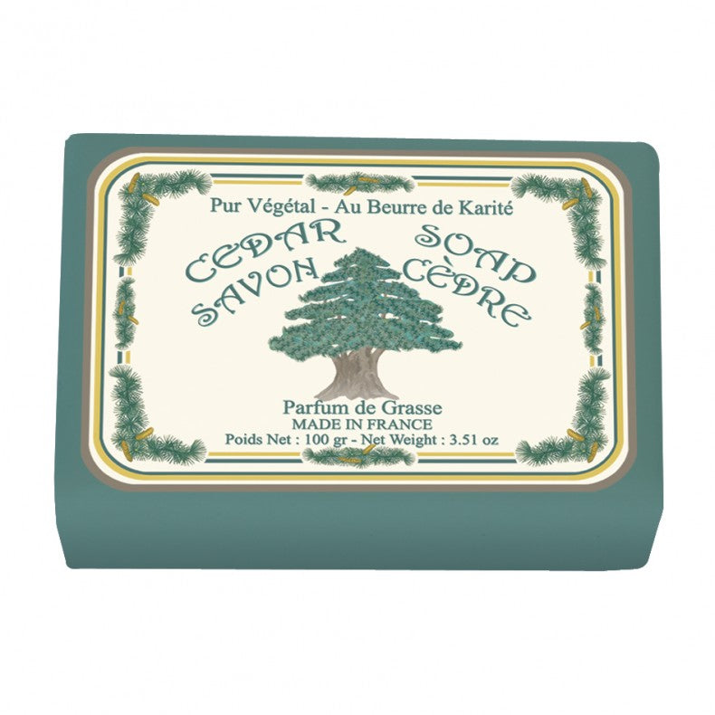 An illustrated soap packaging with a Christmas tree design and text including "Le Blanc Cedar Wrapped Soap", "au beurre de karité", and "cedar fragrance". The packaging is rectangular and colored in soft.
Brand Name: Le Blanc Made in France