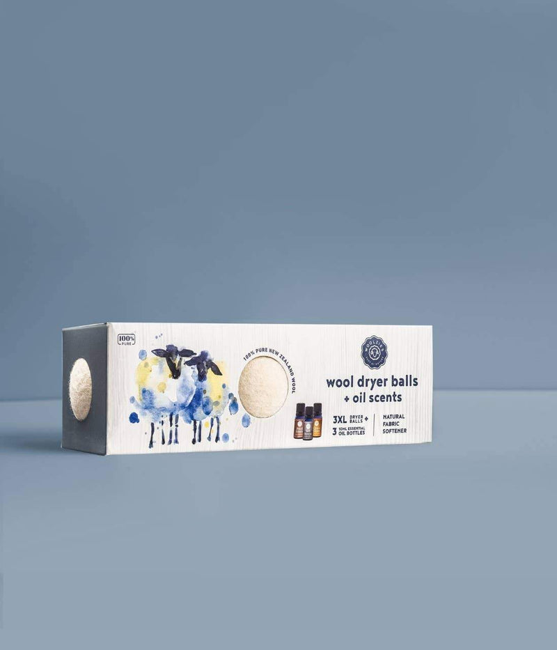 A package of Woolzies Wool Dryer Balls Set of 3 + 3 Laundry Essential oils displayed against a plain blue background, featuring artistic watercolor illustrations of sheep and essential oil bottles.