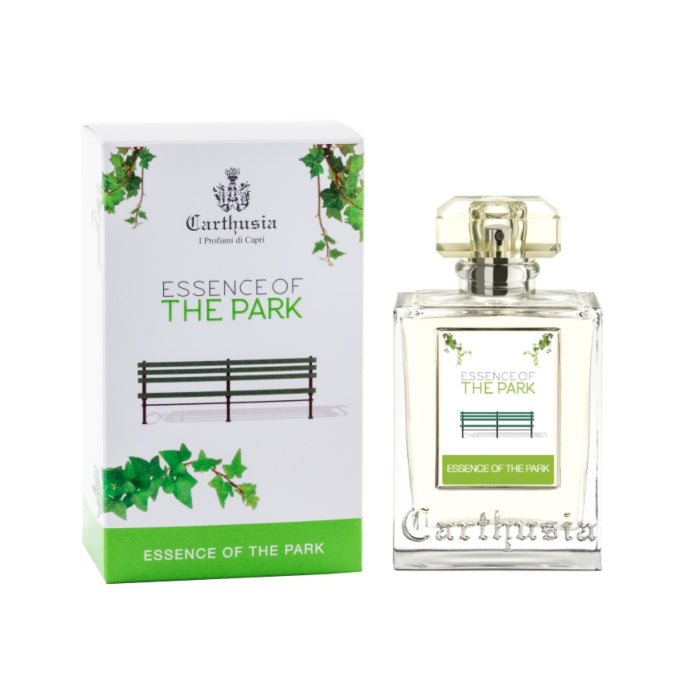A Carthusia Essence of the Park Eau de Parfum - 100ml perfume bottle labeled "essence of the park" exuding notes of citrus fruits, next to its packaging box with a design featuring green foliage and a park bench. Both items bear the Carthusia I Profumi de Capri logo.