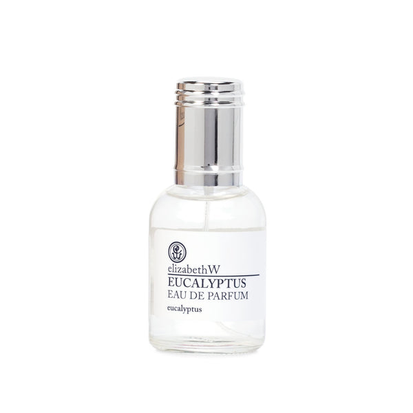The elizabeth W Purely Essential Eucalyptus Eau de Parfum comes in a clear glass bottle with a silver cap, featuring a refined balsamic composition. The white label with black text displays the brand name and eucalyptus scent against a plain white background.