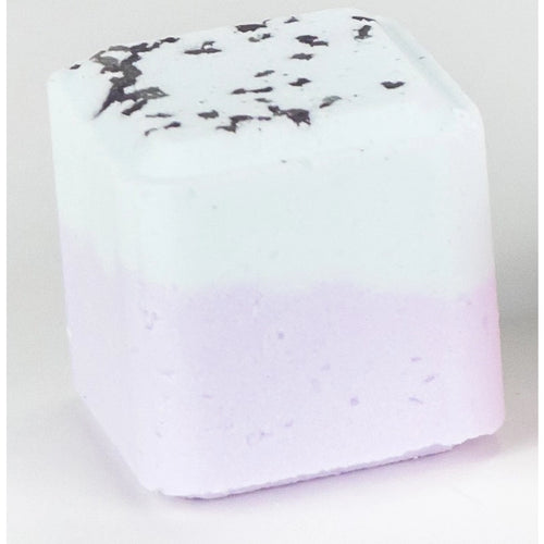 A Lizush Eucalyptus Shower Steamer with a white top sprinkled with black specks and a gradient bottom transitioning from white to light purple, enriched with vegan ingredients, displayed against a plain background.