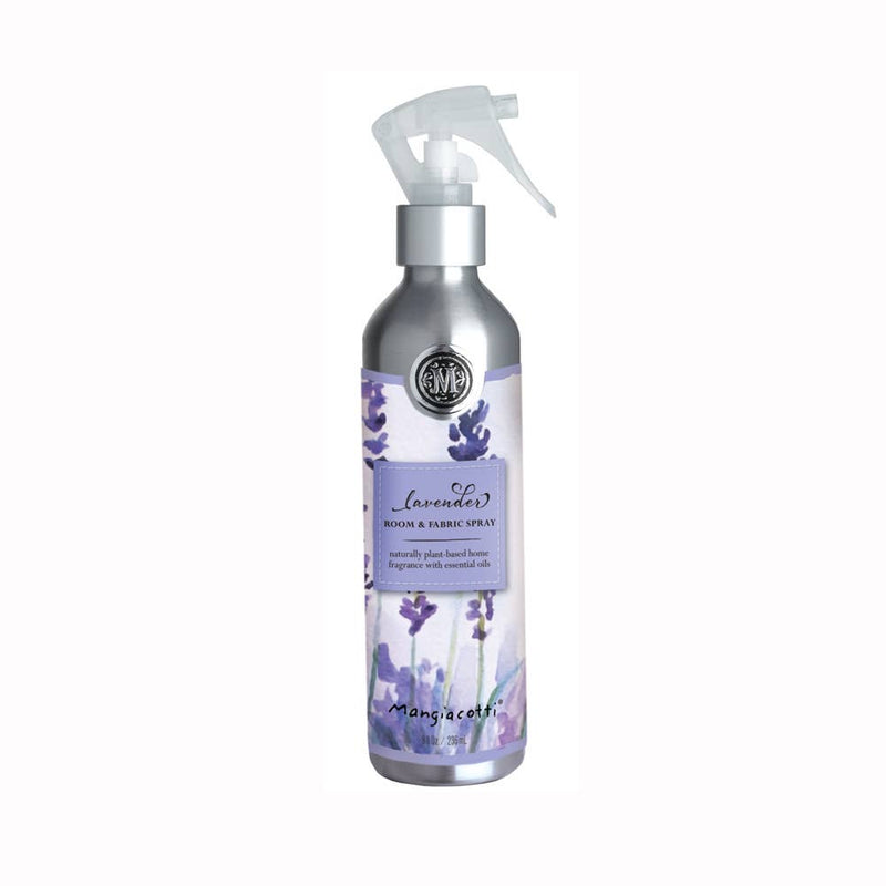 A silver spray bottle labeled "Mangiacotti - NEW! Lavender Room & Fabric Spray" with lavender illustrations and a description emphasizing its naturally scented, biodegradable contents, enriched with essential oils.