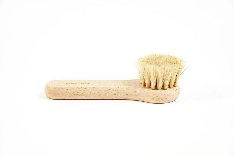 An Andrée Jardin Tradition Face Cleansing Brush Waxed Beech Wood with natural bristles lies on a plain white background, showcasing its simple and ergonomic design.