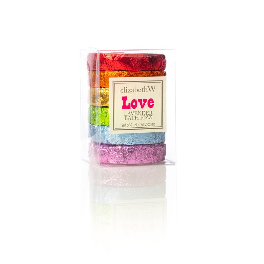 A clear plastic box containing a set of six colorful handmade fragrant fizz tablets, stacked vertically and labeled "elizabeth W Love Lavender Set of 6 Fizz Tablets".