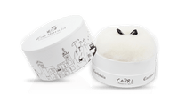 A round white box with black cityscape line art and "Carthusia I Profumi di Capri" and "Capri" on the lid holds fluffy dusting powder in Forget Me Not scent—luxury from Carthusia Capri Forget Me Not Dusting Powder.
