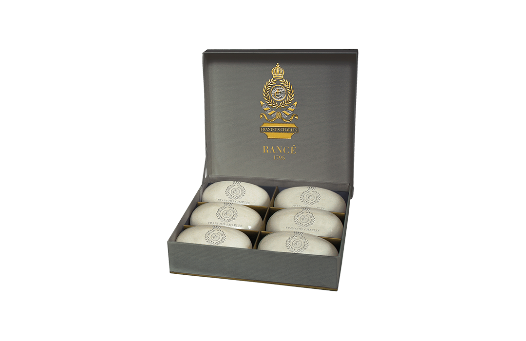 A box of Rance Francois Charles Boxed Soap - 6's with elegant packaging. The box is dark gray with gold lettering that reads "Range D76" and features a crest logo inspired by Jean Rancé. Inside, four bars of soap are displayed beautifully.