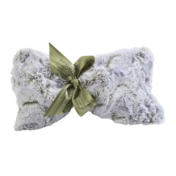 A soft, light gray faux fur pillow tied with an olive green ribbon pairs perfectly with the Sonoma Lavender Sonoma Eucalyptus Frosted Moss Sinus Mask for relaxing comfort and a plush, cozy feel.