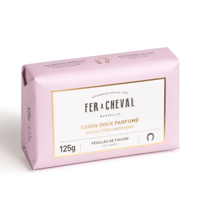 A light pink Fer à Cheval Gentle Perfumed Soap Bar wrapped in labeled packaging that reads "fer à cheval savon doux gentle perfumed soap" with additional text and a weight indication of 125g.