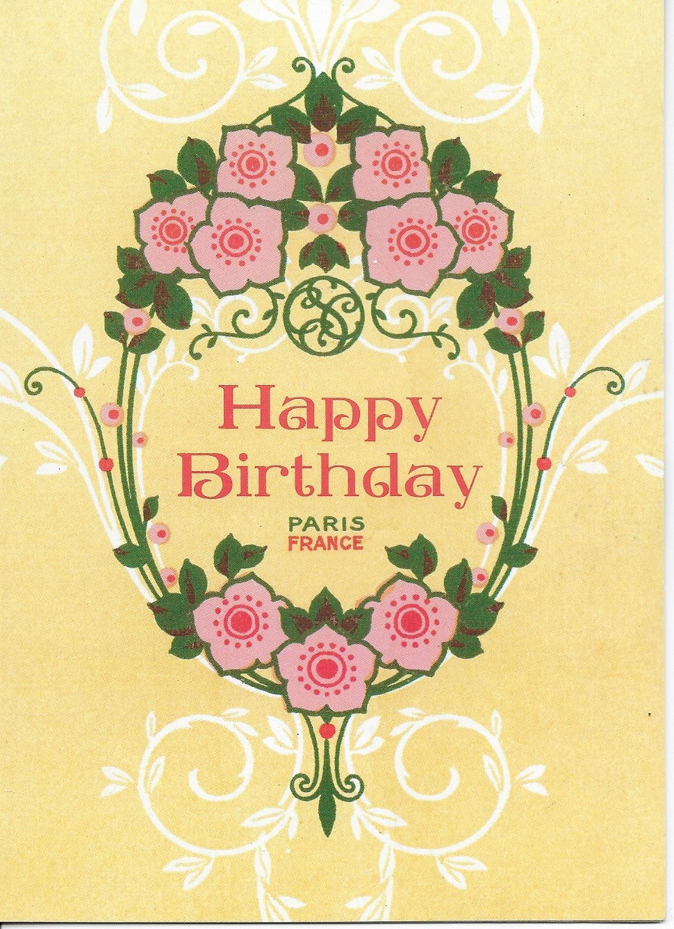 A Greeting Cards birthday greeting card with the text "happy birthday" in pink, centered in a decorative floral wreath with symmetrical roses and leaves, against a yellow background. Below the text is "Paris France".