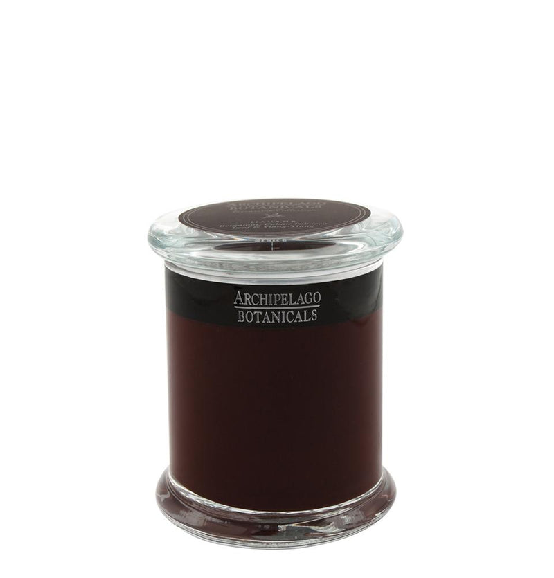 A Archipelago Botanicals Archipelago Excursion Havana Glass Jar Candle with a dark brown wax labeled "Havana home fragrance" on a white background. The jar has a clear lid.