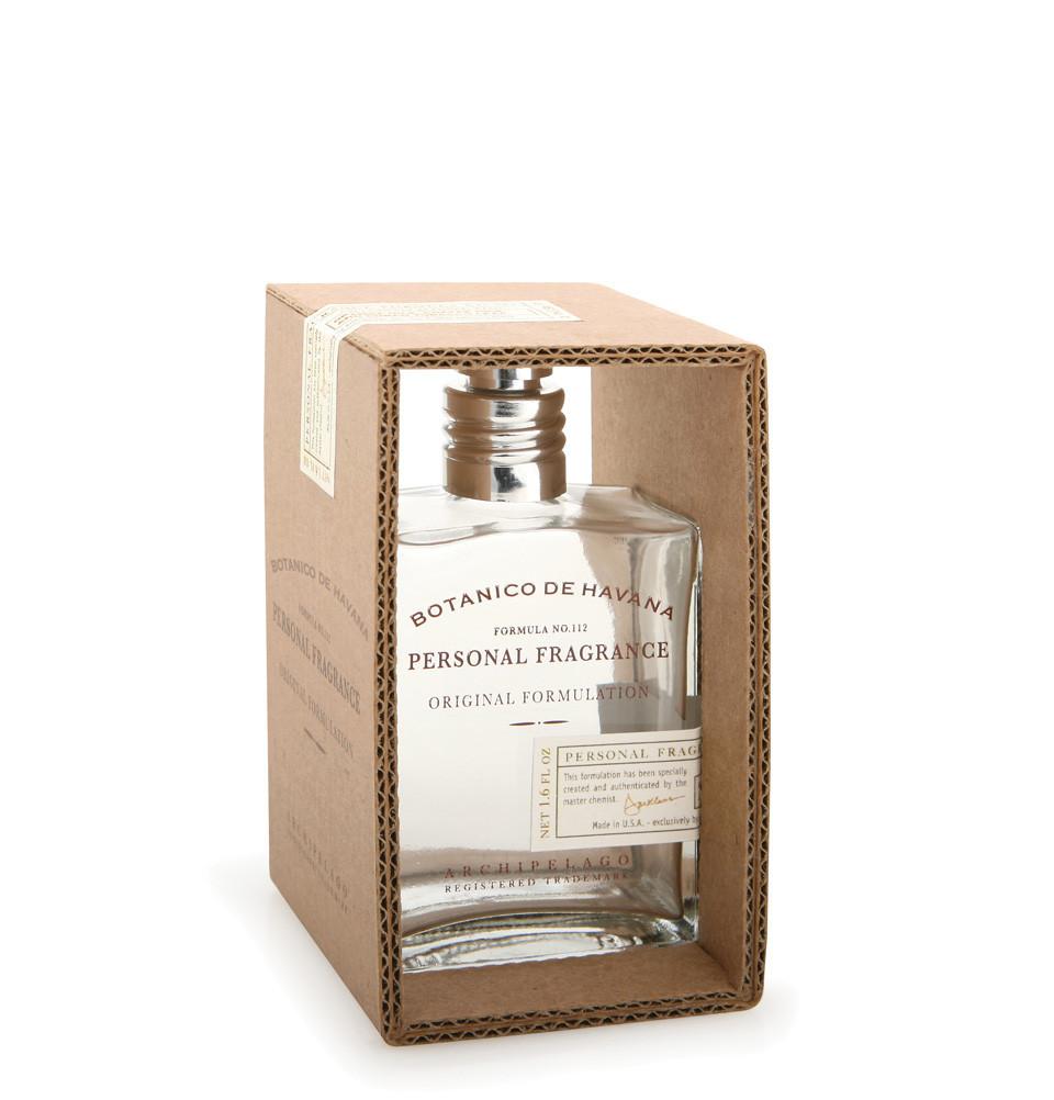 A square glass bottle of Archipelago Botanico de Havana Personal Fragrance by Archipelago Botanicals partially inside an open brown cardboard box with visible text. The bottle has a silver cap and contains an intoxicating fragrance blend.