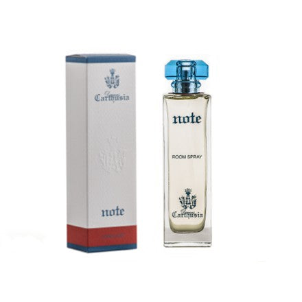 A home fragrance spray bottle labeled "Carthusia Corallium Note" next to its packaging box, both adorned with an elegant crest logo. The box has a grey body with a blue top and bottom, while.