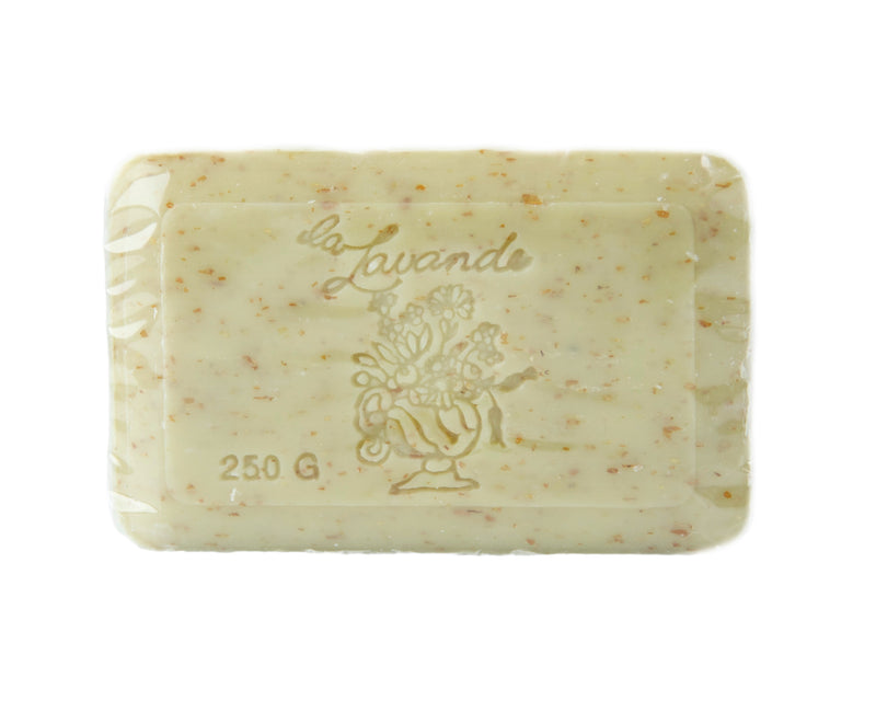 A bar of La Lavande Honey Almond 250gm soap, with embedded flower particles and embossed with the text "la lavande" and a floral design. The background is plain white.