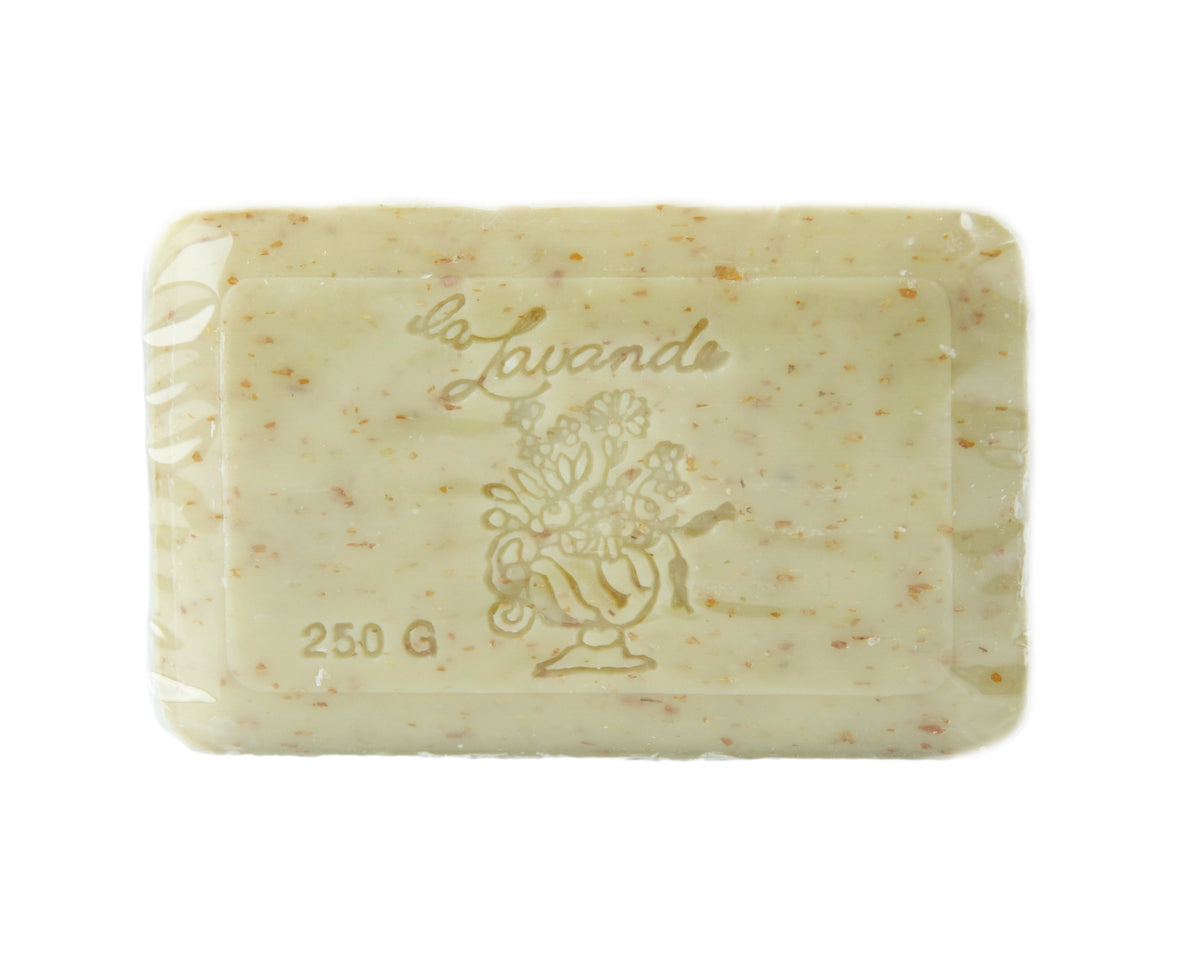 A bar of La Lavande Honey Almond 250gm soap, with embedded flower particles and embossed with the text "la lavande" and a floral design. The background is plain white.