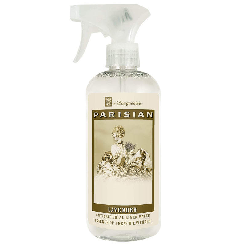 A clear spray bottle of "La Bouquetiere Lavender Antibacterial Linen Water" with a vintage style label featuring a classical illustration of a woman and floral designs.