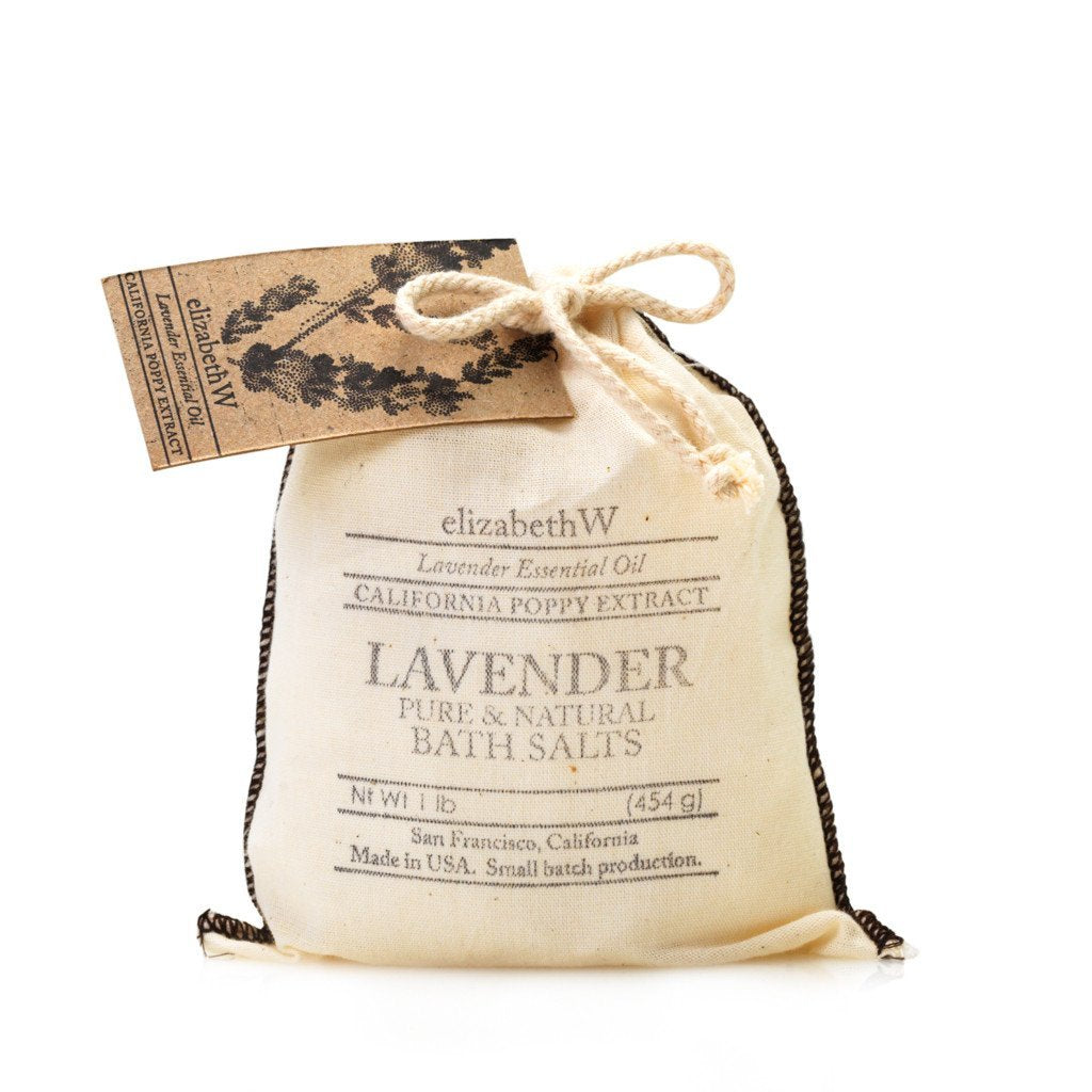 A small, beige fabric pouch with a rustic drawstring, labeled "elizabeth W Purely Essential Lavender Bag of Salts" and a tag indicating lavender essential oil and California poppy extract, isolated on a white background