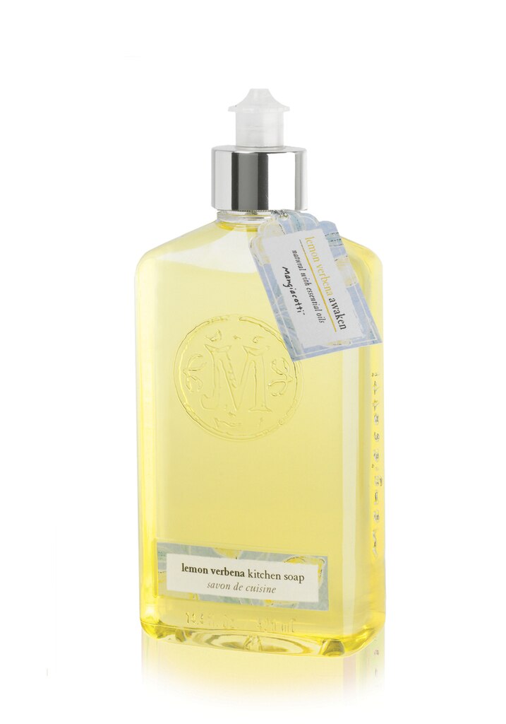 A clear bottle of Mangiacotti Lemon Verbena Natural Kitchen Soap with a pump dispenser, labeled with an ornate monogram and attached with a blue and white descriptive tag containing essential oils.
