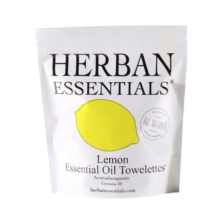 A package of Herban Essentials Essential Oil Towelettes - Lemon, labeled "all natural" and "aromatherapeutic," with an image of a lemon on the front.