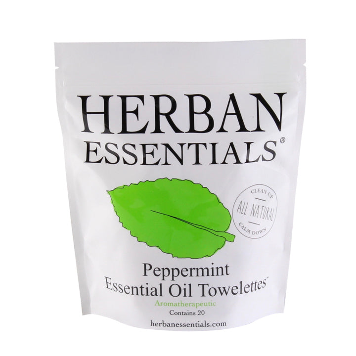 A package of Herban Essentials Essential Oil Towelettes - Peppermint, displaying a prominent green leaf and text indicating "all natural". The package asserts it contains 20 towelettes with an energizing aroma.