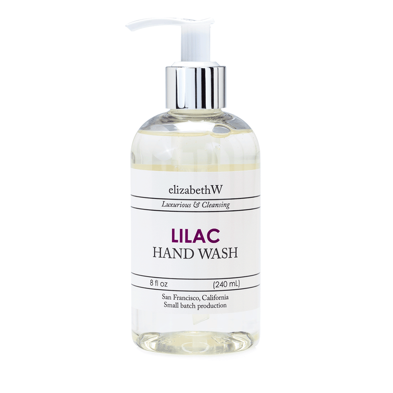 A clear bottle of elizabeth W Small Batch Apothecary Lilac Hand Wash with a pump dispenser, labeled in a simple, elegant design, indicating the product is an 8 oz (240 ml) size.