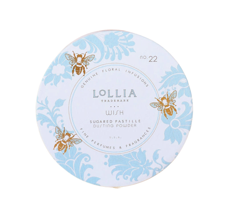 A circular tin of Margot Elena Lollia Wish Dusting Powder with a light blue label, featuring elegant gold and blue floral designs and bees.
