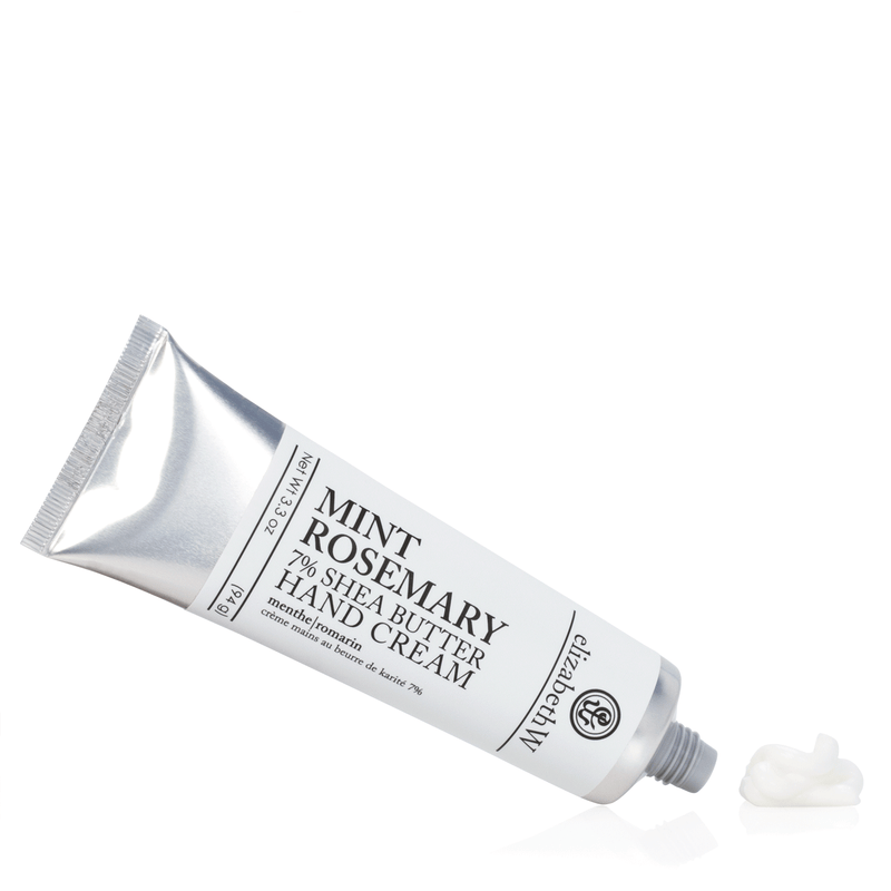 A tube of elizabeth W Purely Essential Mint Rosemary Hand Cream titled "palm balm" with a small amount of cream squeezed out, lying against a white background.