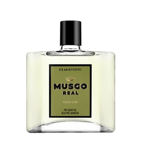 A square glass bottle of Claus Porto 1887 Musgo Real Classic Scent pre-shave oil for sensitive skin, with a cream label featuring black and olive green text, against a white background.