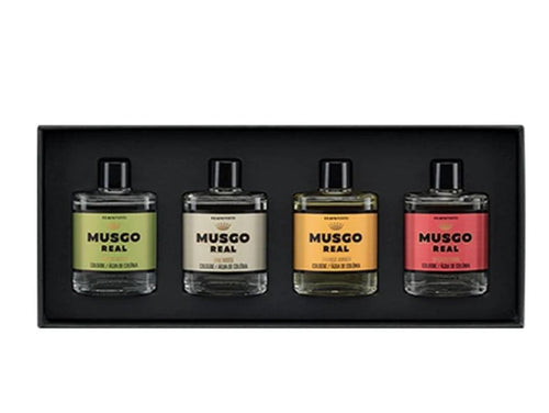 The Claus Porto Gift Box of 4 Mini Musgo Real Colognes by Claus Porto 1887 features four rectangular bottles in a black box, each with a unique colored label—green, cream, yellow, and red—capturing signature masculine scents.